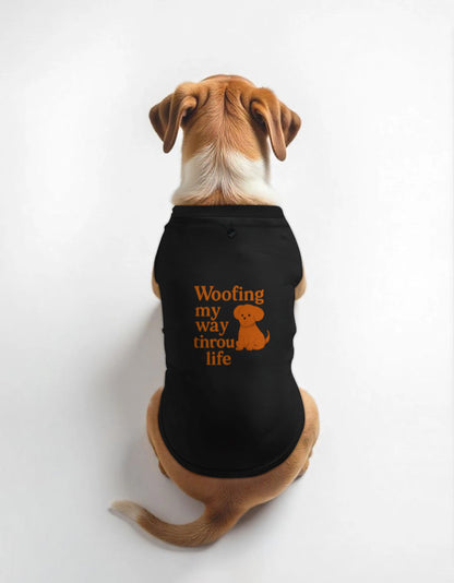 Dog wearing a black shirt with 'Woofing my way through life' text and dog graphic on a white background